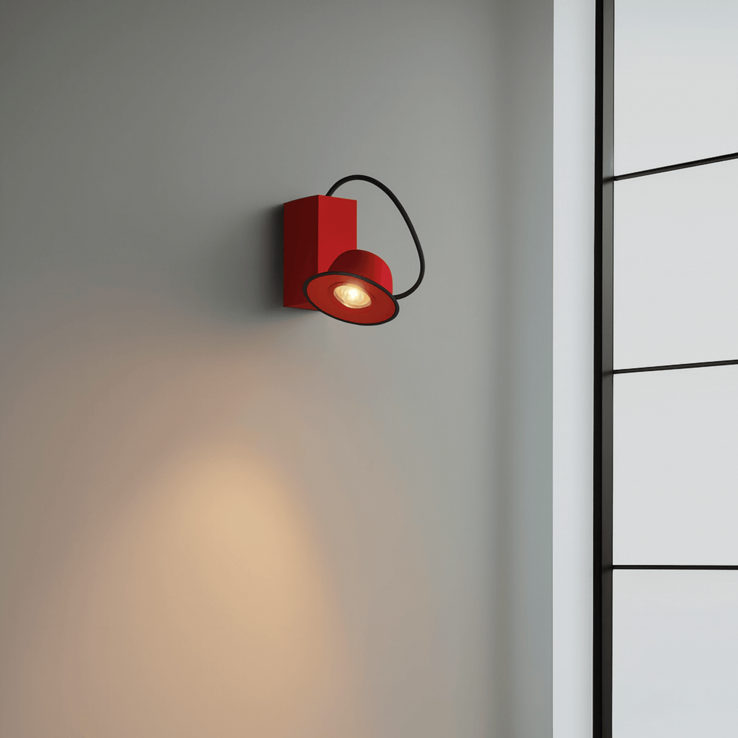 Red wall light fixture on a gray wall with a black metal ladder in the background
