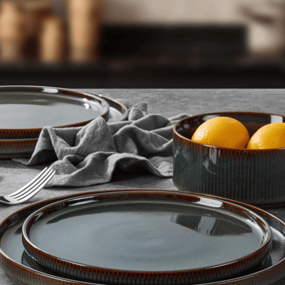 Ceramic plates and bowl with lemons on a table