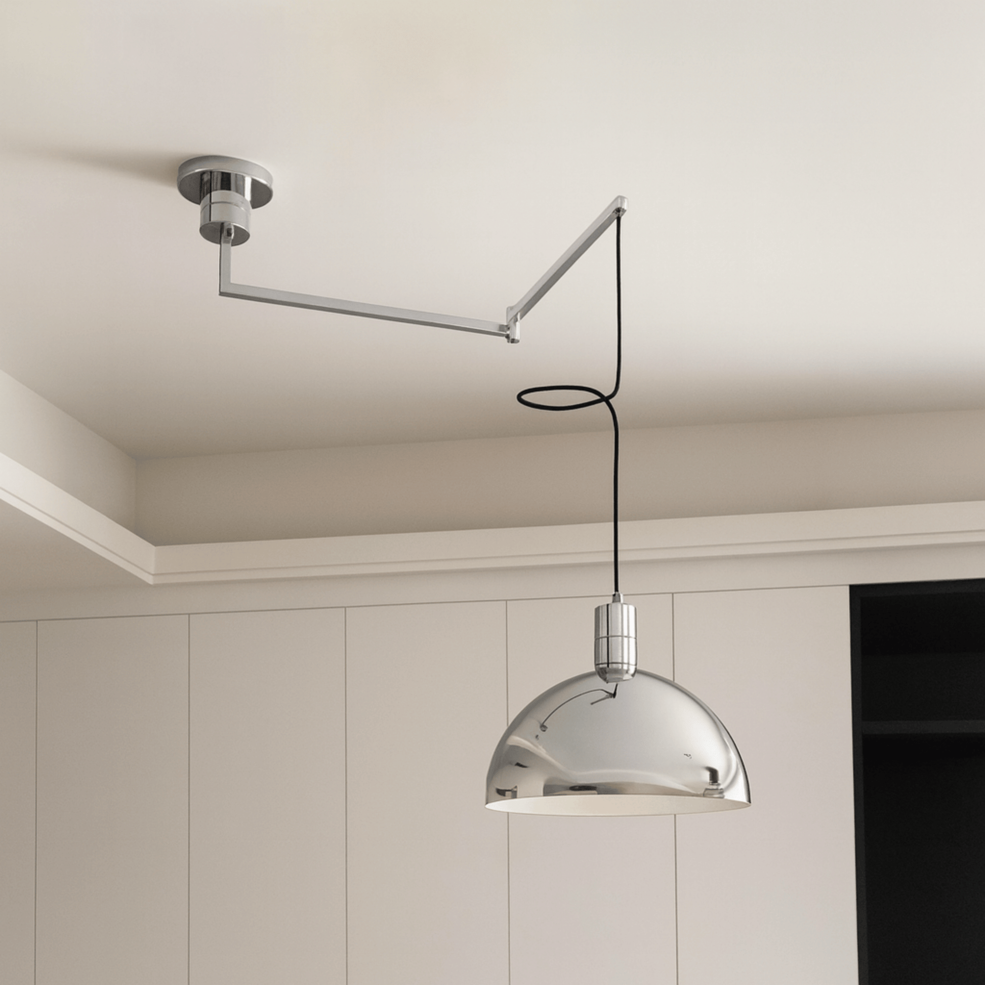 Modern pendant light with adjustable arm in a neutral setting