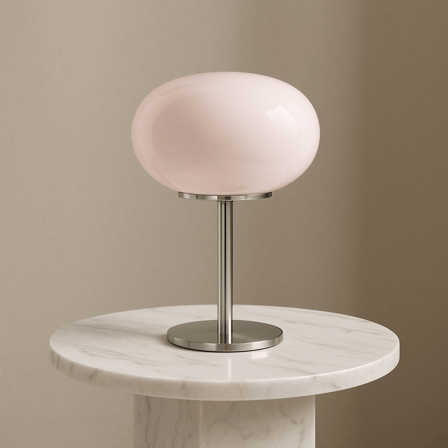 Table lamp with a pink glass shade on a marble base against a beige wall