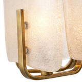 Decorative lamp with gold frame and textured white shade on a white background