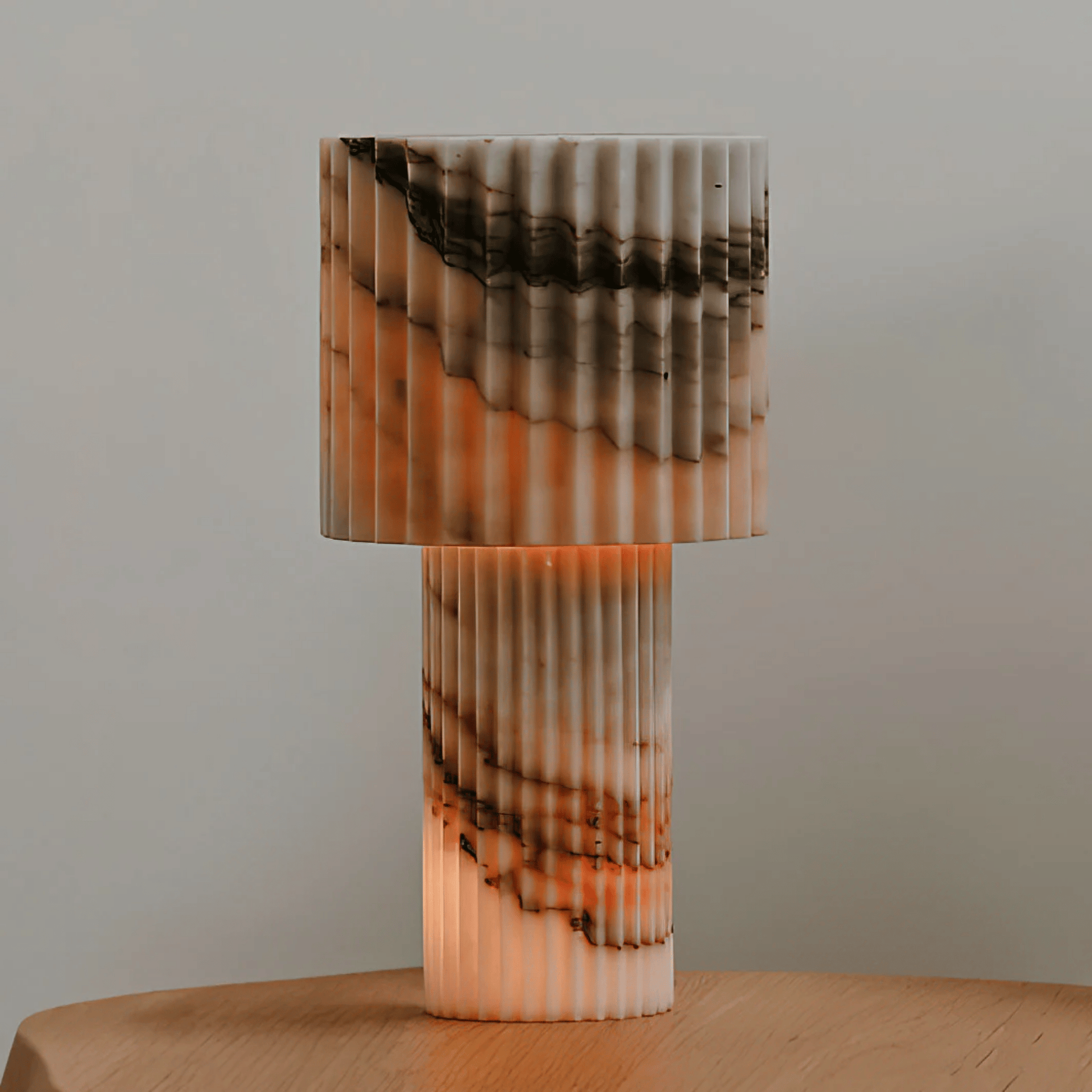 Marble-patterned table lamp on a wooden surface with a neutral background