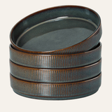 Set of three ceramic bowls with a textured surface on a white background