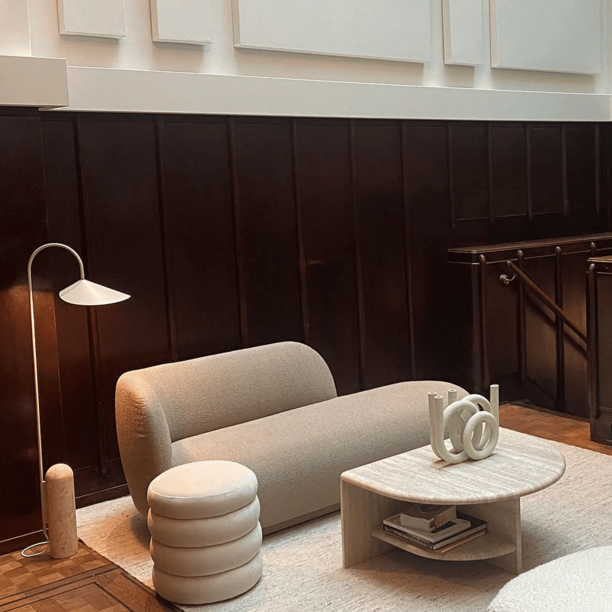 Modern living room with a beige sofa, coffee table, and decorative items.