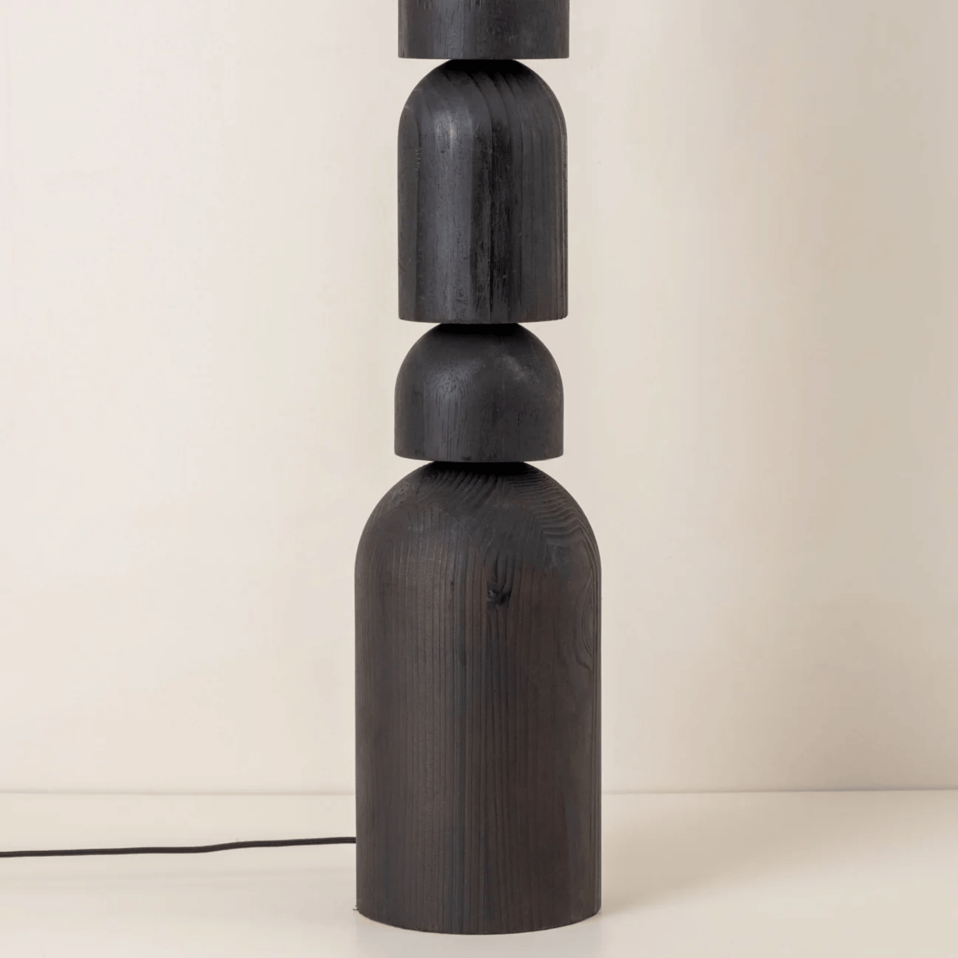 Dark wooden lamp with cylindrical design on a light background