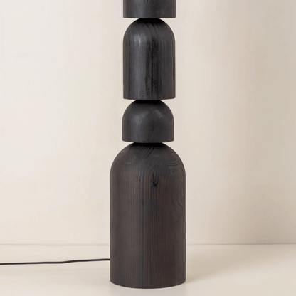 Dark wooden lamp with cylindrical design on a light background