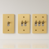 Three beige light switch covers with different numbers of switches on a white background
