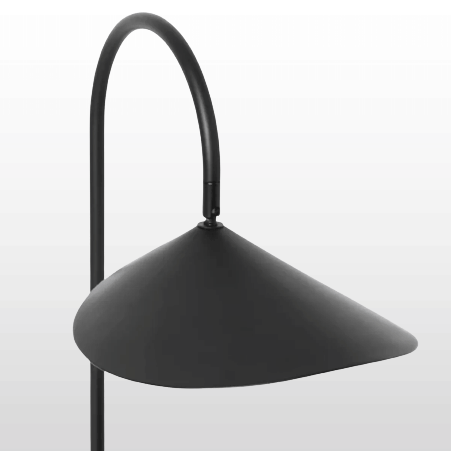 Black floor lamp with a curved neck on a light gray background