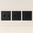 Three black wall switches and outlets on a beige background