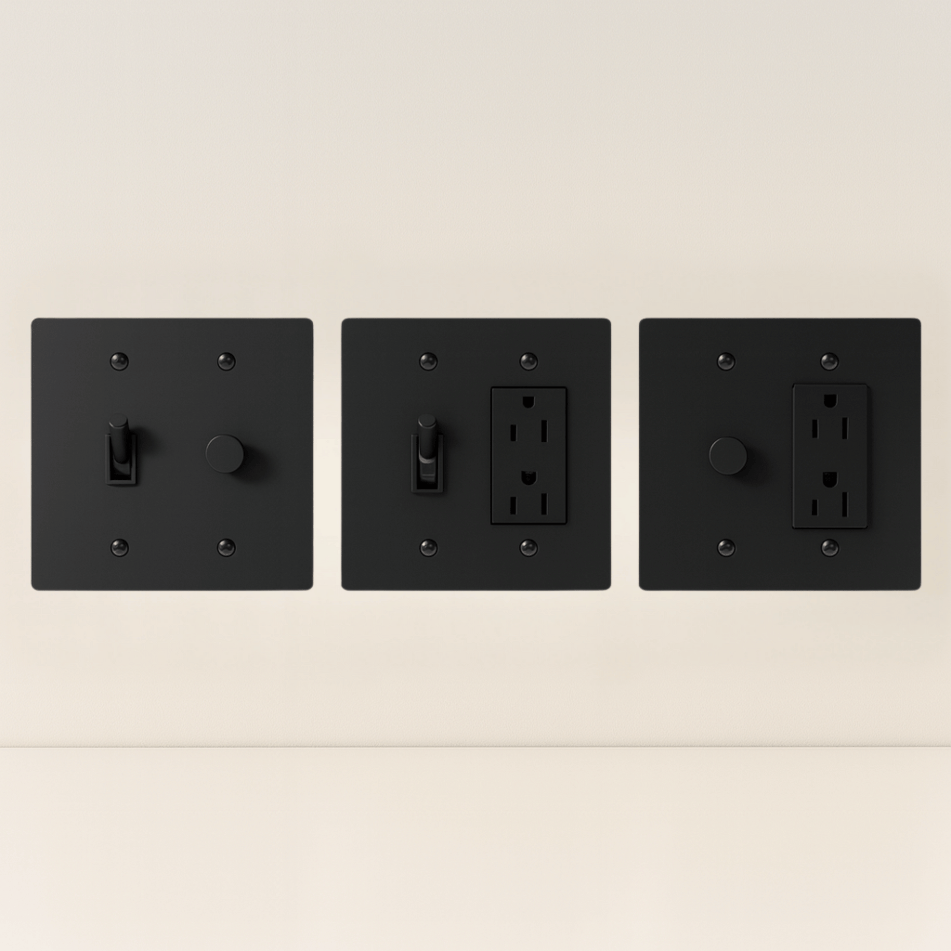 Three black wall switches and outlets on a beige background