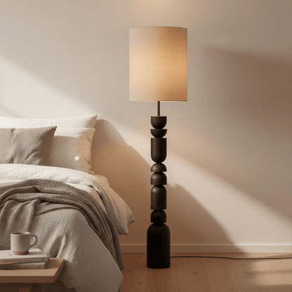 Floor lamp with a beige shade in a bedroom setting