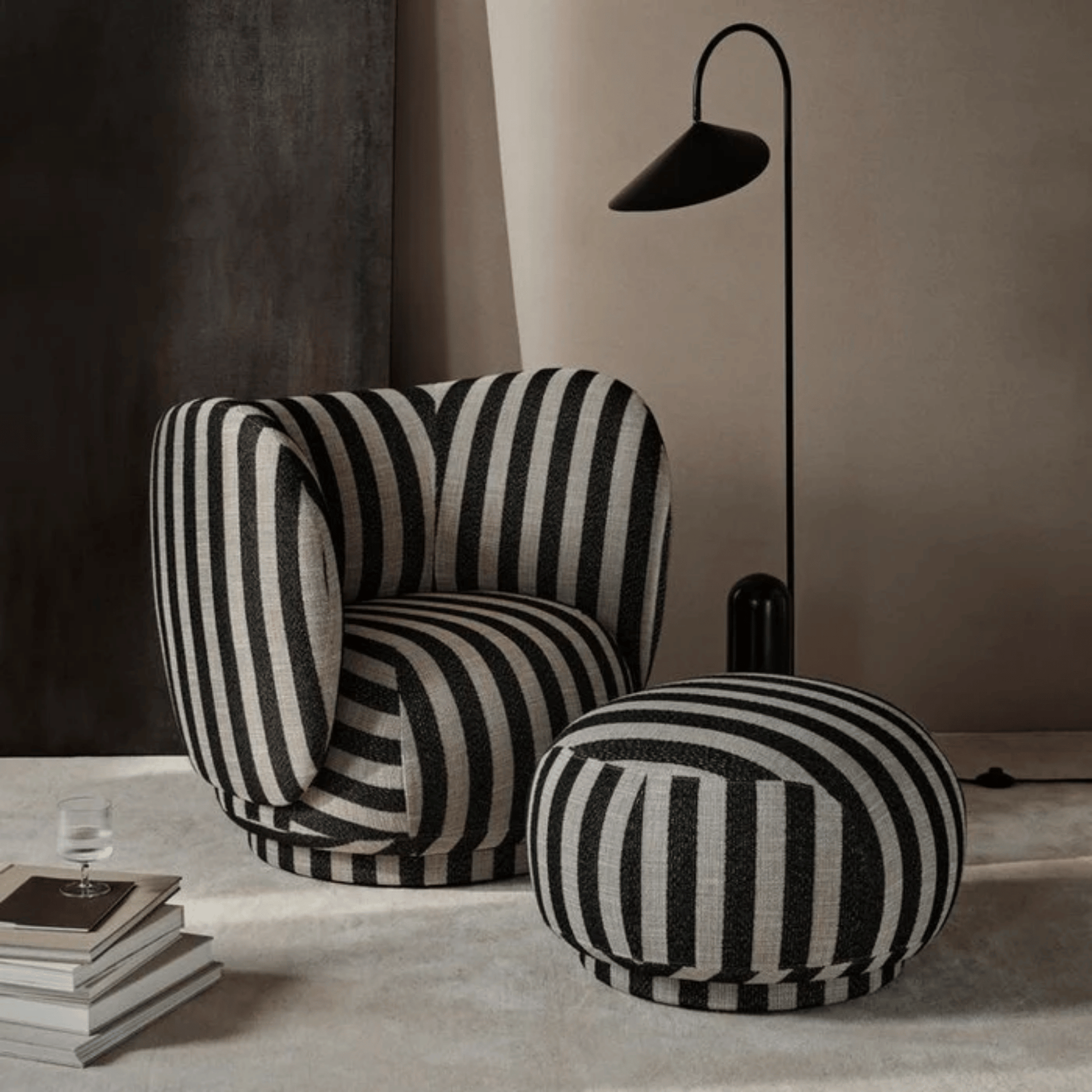 Black and white striped armchair and ottoman in a modern interior setting.
