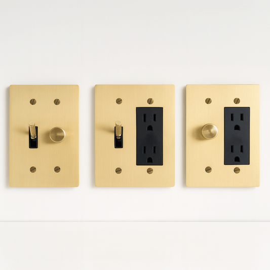 Three gold light switch and outlet covers on a white background