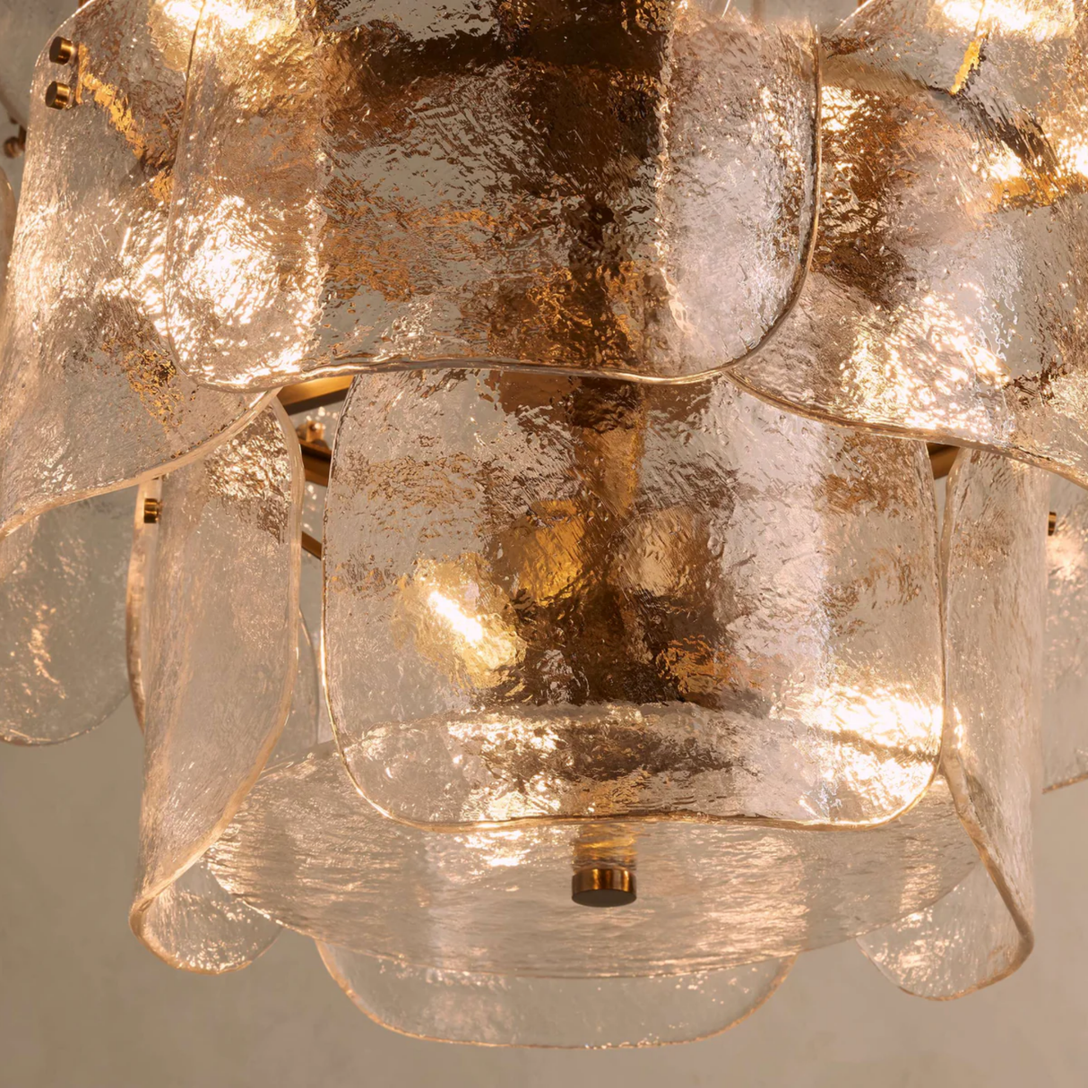 Close-up of a decorative chandelier with glass shades on a neutral background