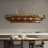 Modern chandelier hanging above a dining table with chairs in a neutral setting