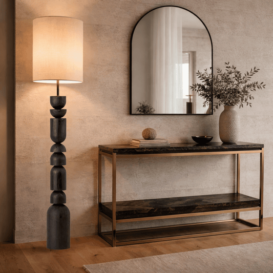 Modern interior with a console table, mirror, and lamp against a beige wall.