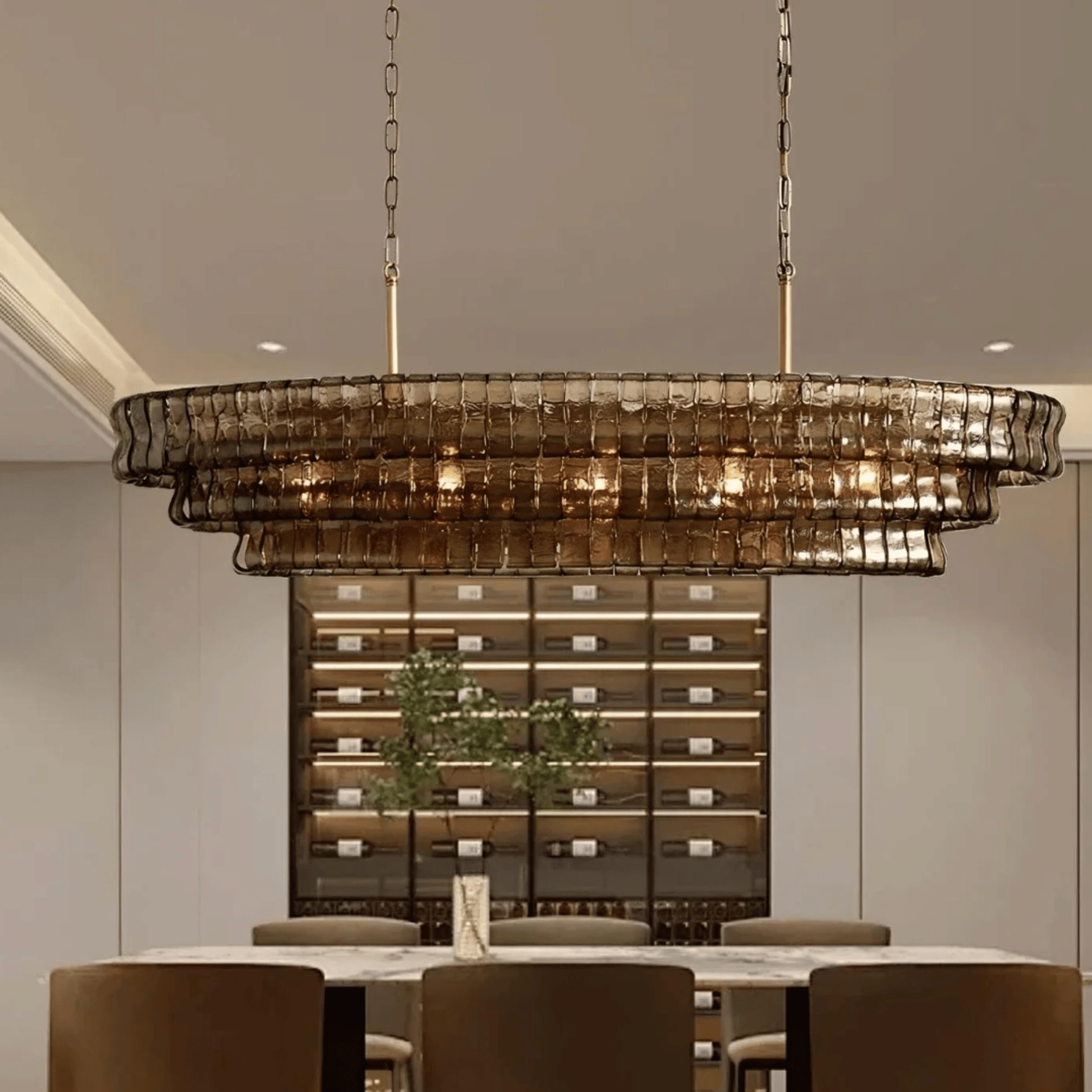 Chandelier hanging above a dining table with a wine cellar in the background