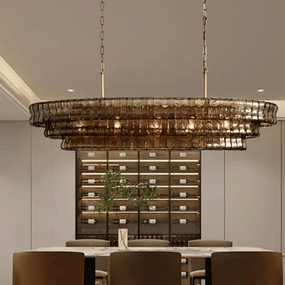 Chandelier hanging above a dining table with a wine cellar in the background
