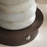Decorative lamp with marble-like design and wooden base on a light background