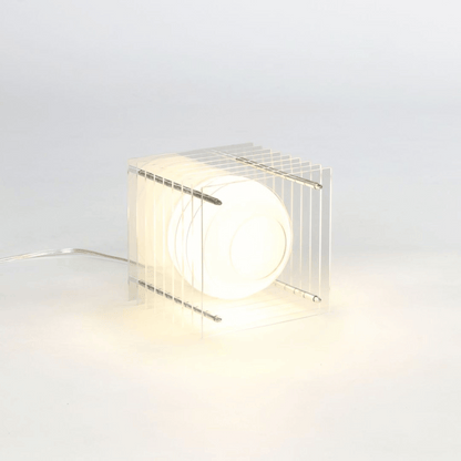 Modern table lamp with wire cage design on a light gray background
