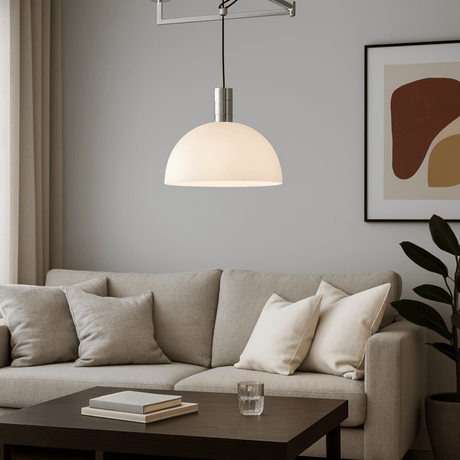Modern living room with a gray sofa, coffee table, and pendant light.