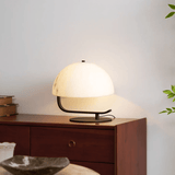Table lamp on a wooden side table with a neutral background