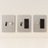 Three light switch and outlet covers on a white wall.