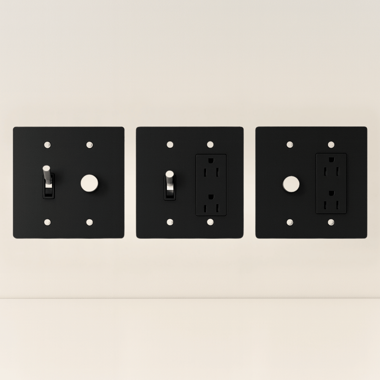 Three black wall plates with different electrical symbols on a beige background