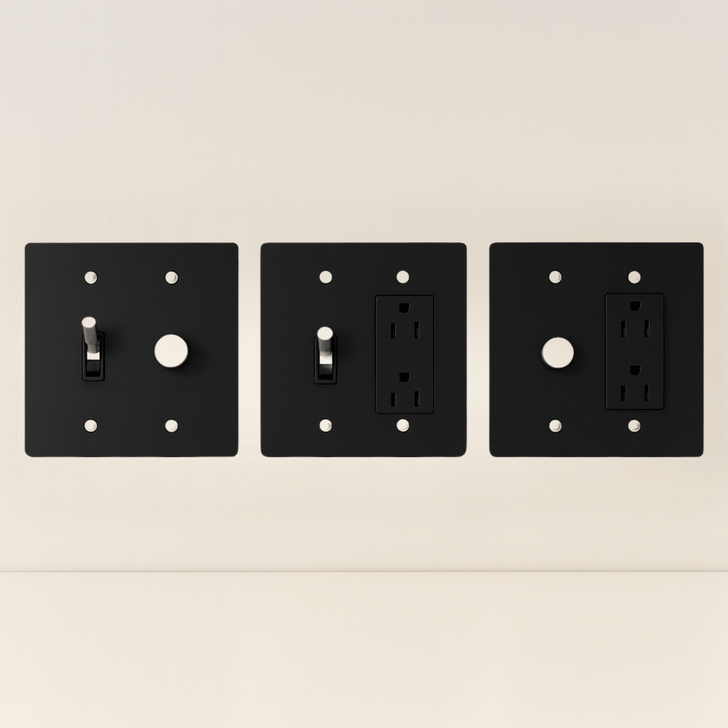 Three black wall plates with different electrical symbols on a beige background