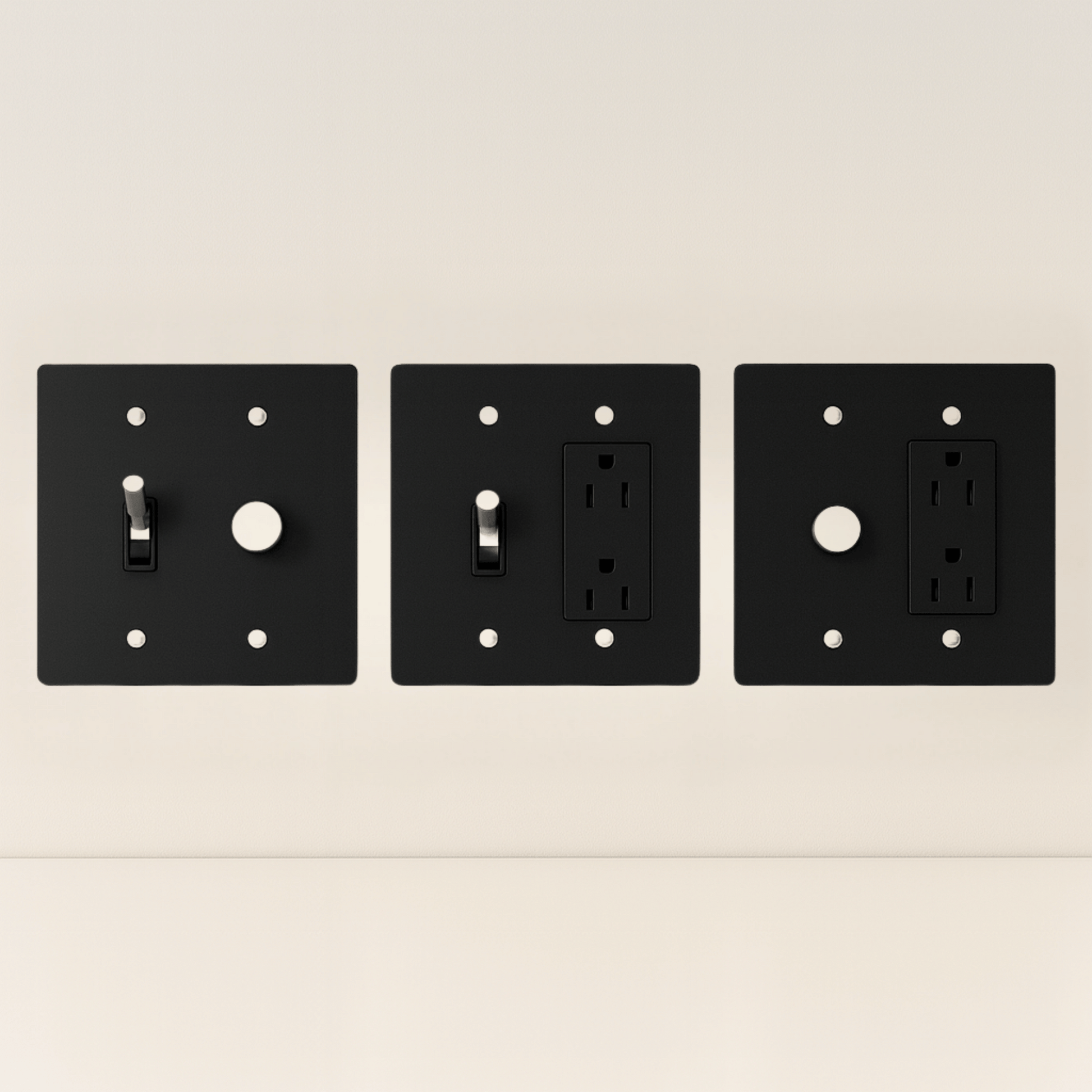 Three black wall plates with different electrical symbols on a beige background