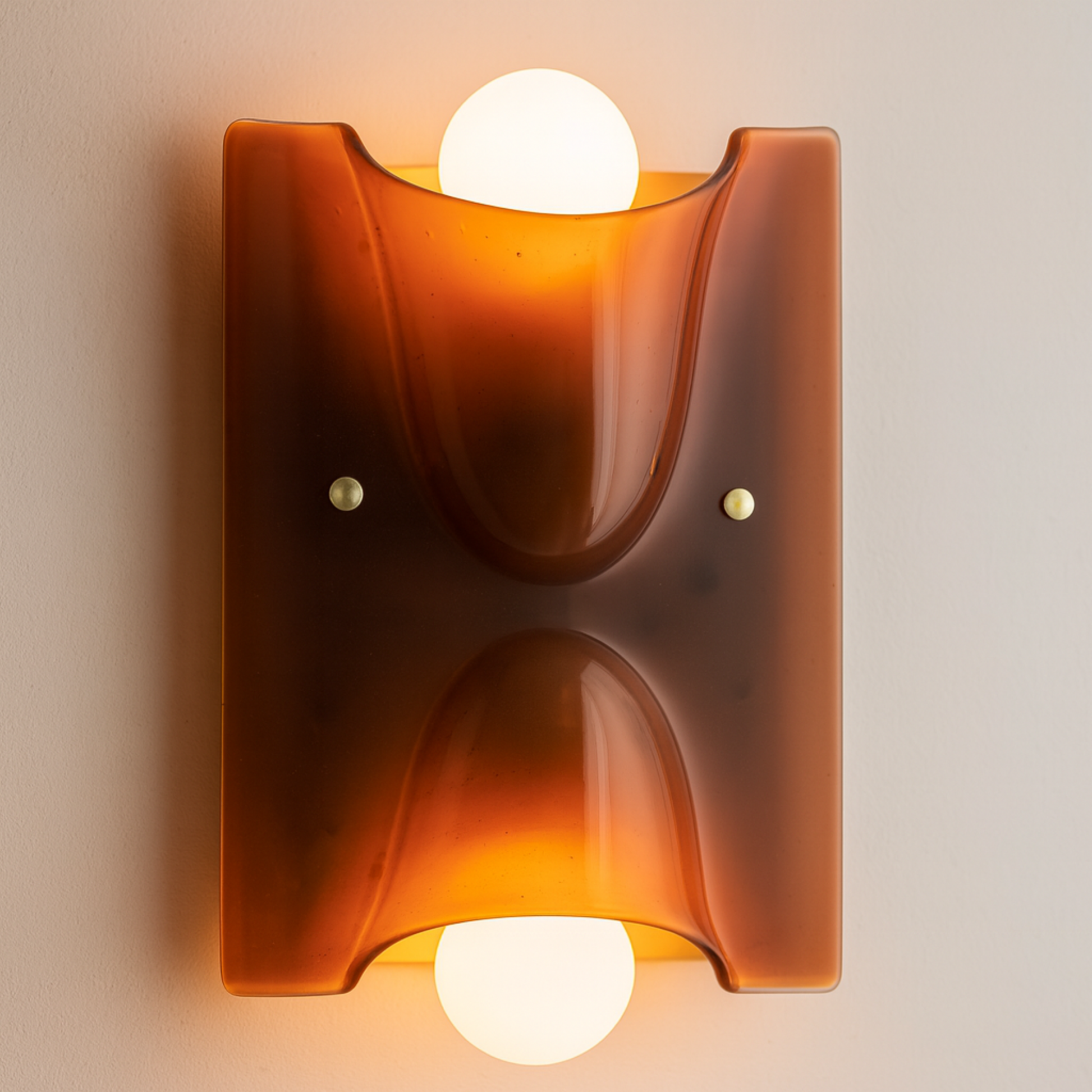 Wall-mounted light fixture with a warm glow on a beige wall.