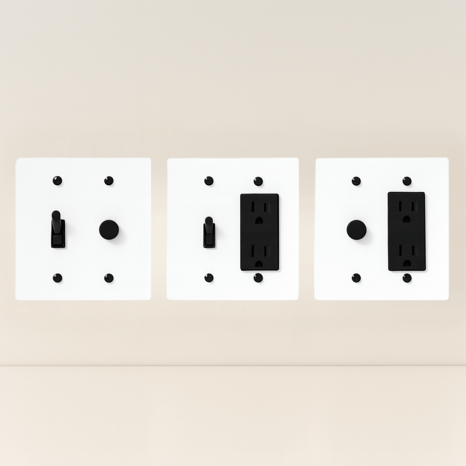 Three white wall plate covers with black outlets on a beige background