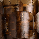 Close-up of a textured metallic surface with a focus on the material's sheen and color variations.