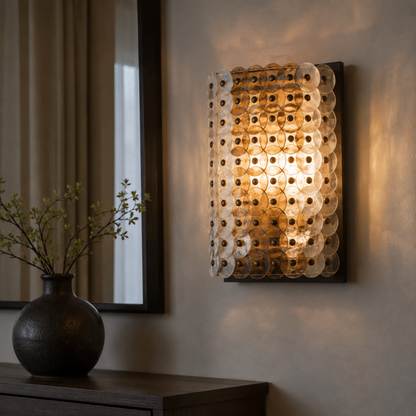 Decorative wall sconce with a vase and plant on a table in a room setting