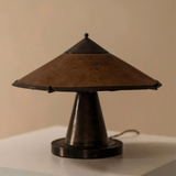 Vintage-style table lamp with brown shade and black base on a neutral background
