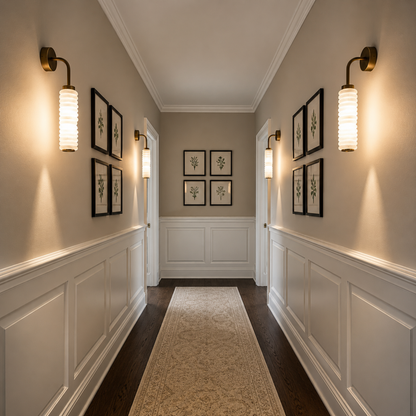 Elegant hallway with decorative wall lights, framed pictures, and a runner.