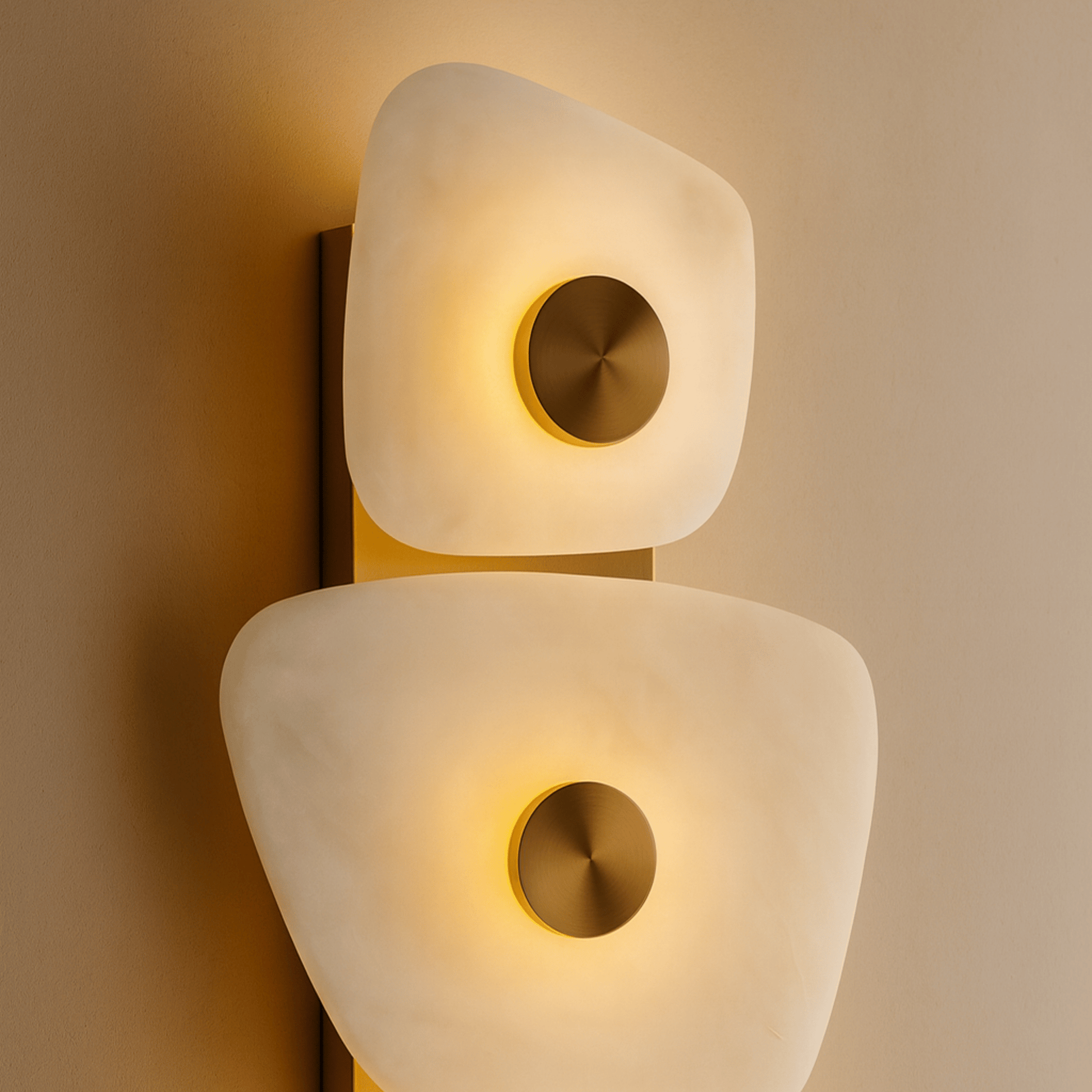 Modern wall lamp with two triangular shades on a beige wall