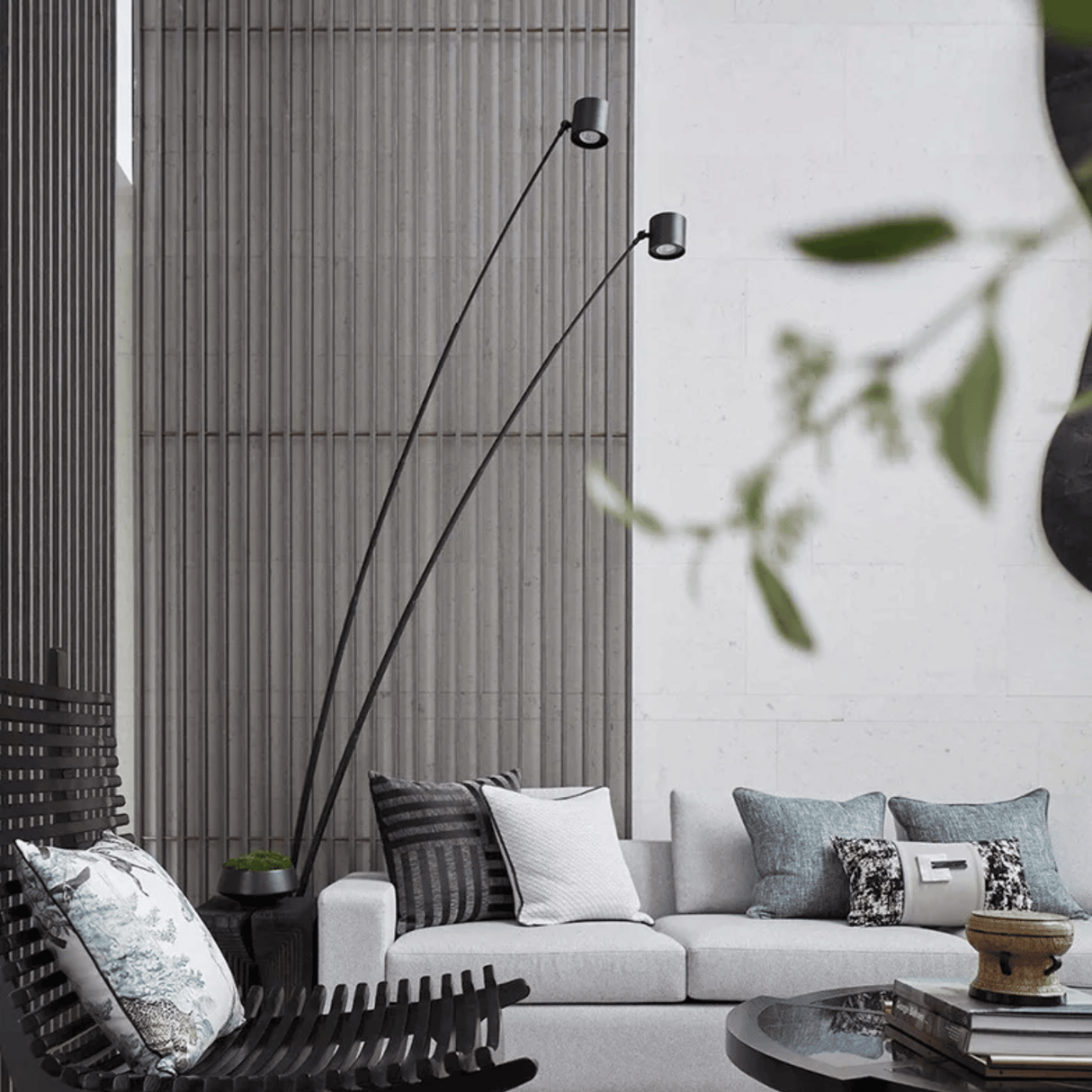 Modern living room with a white sofa, decorative pillows, and a tall floor lamp.