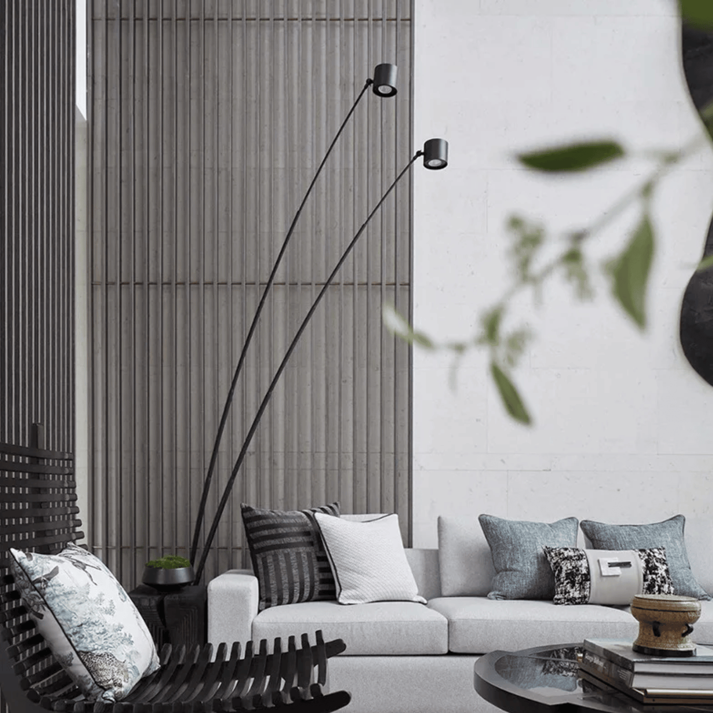 Modern living room with a white sofa, decorative pillows, and a tall floor lamp.