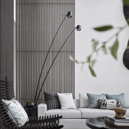 Modern living room with a white sofa, decorative pillows, and a tall floor lamp.