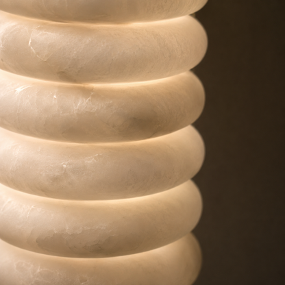 Close-up of a textured beige vase against a dark background