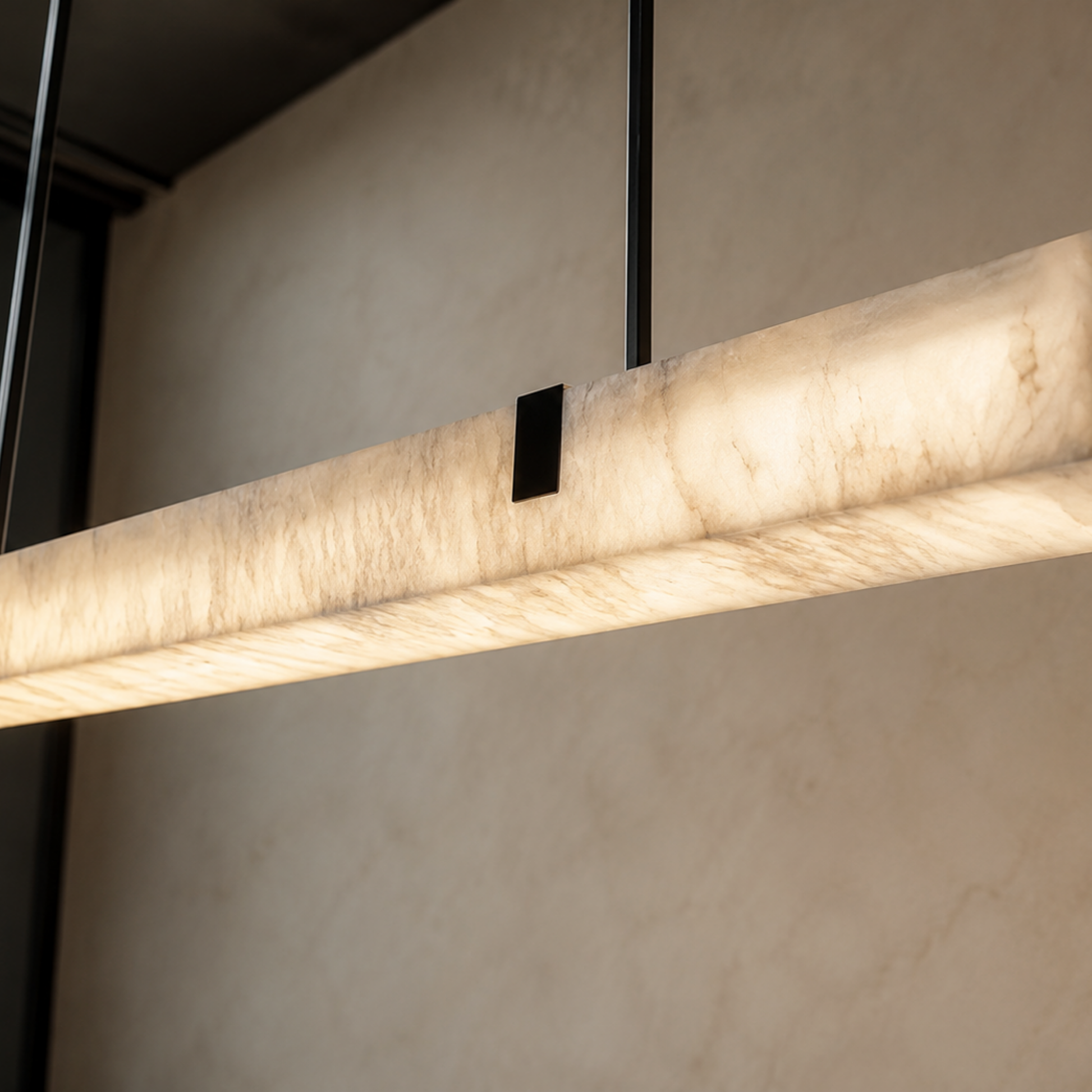 Modern pendant light fixture with marble-like finish on a neutral background