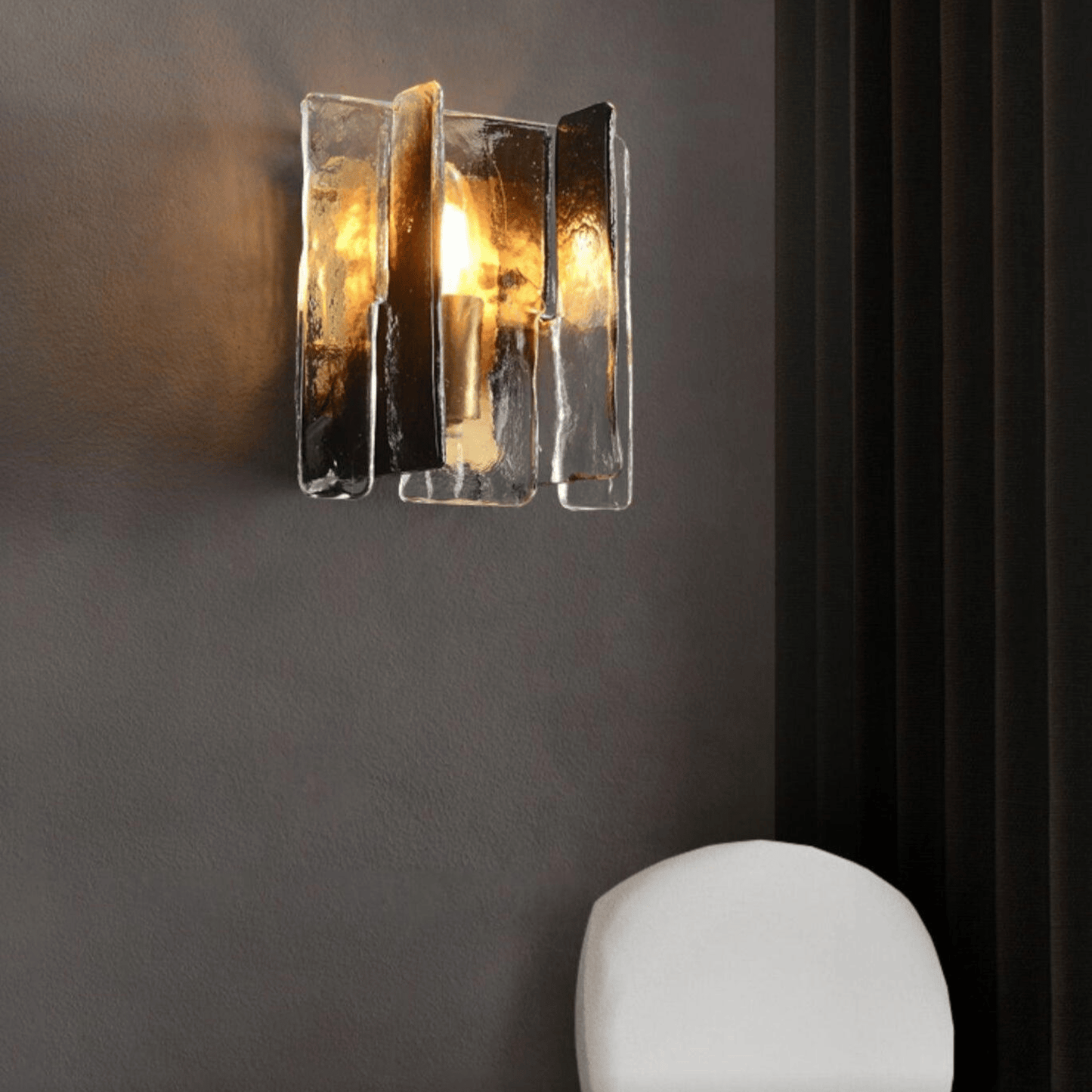 Modern wall sconce with glass panels on a dark wall