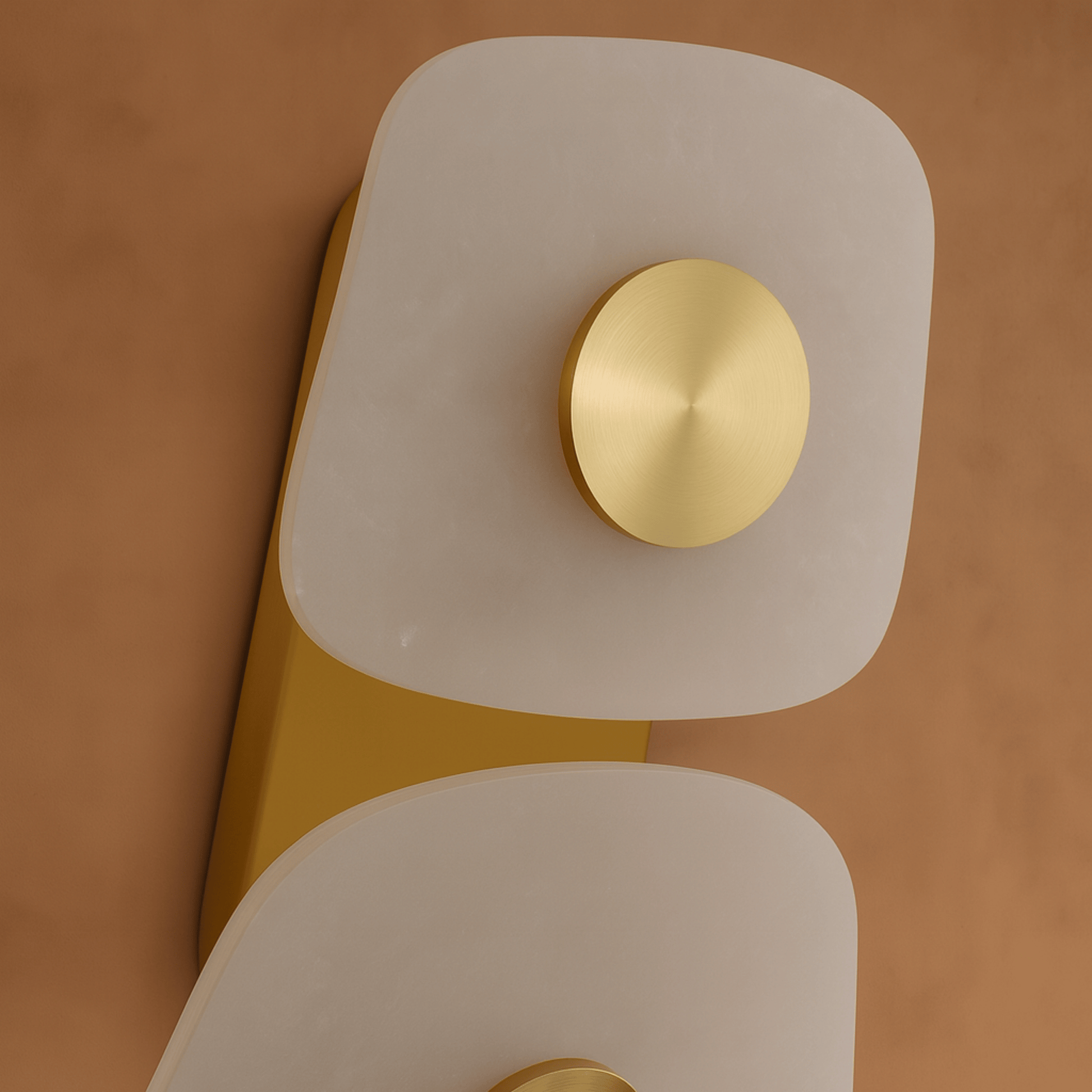 Decorative wall light fixture with gold and white design on a brown background