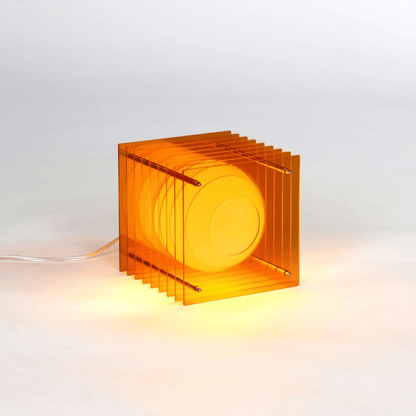 Orange transparent cube lamp on a white background