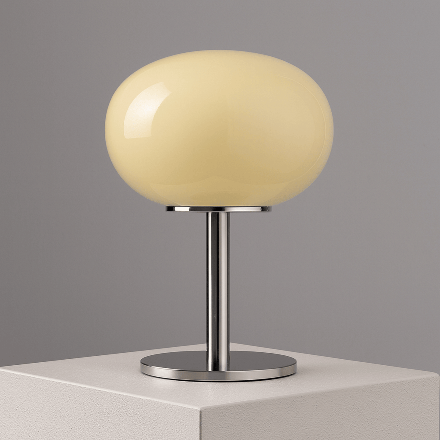 Table lamp with a beige spherical shade on a gray background