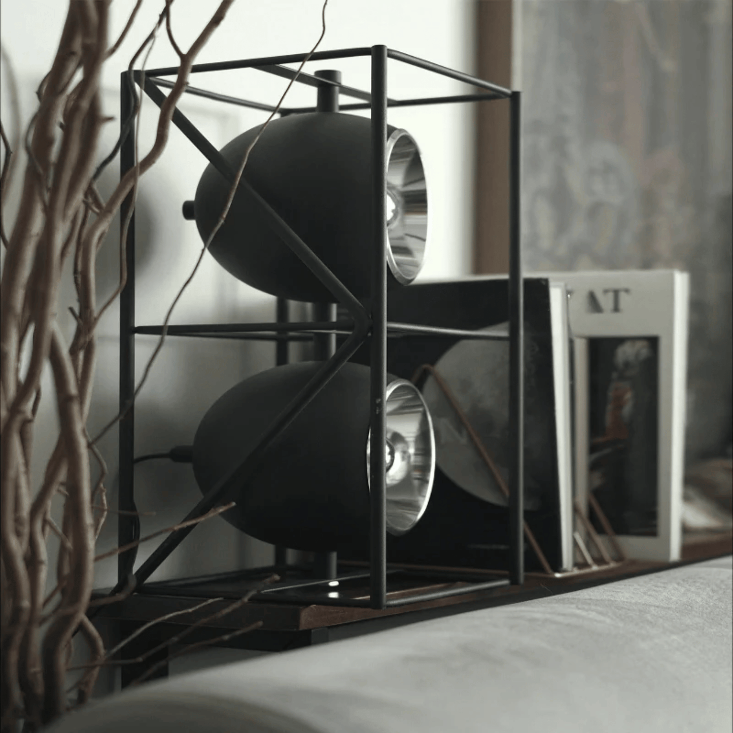 Modern black metal shelf with decorative items in a home setting