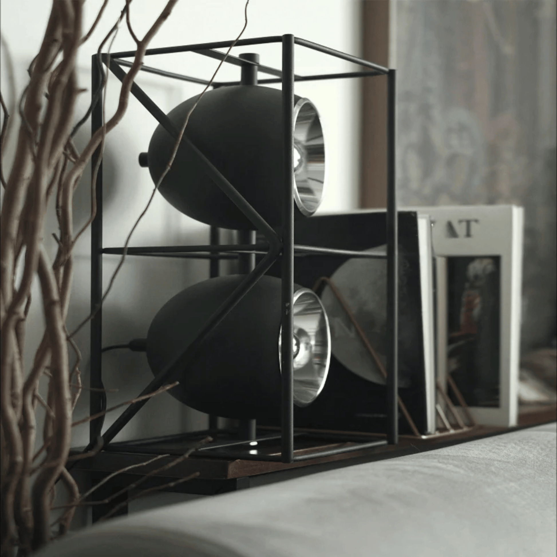 Modern black metal shelf with decorative items in a home setting