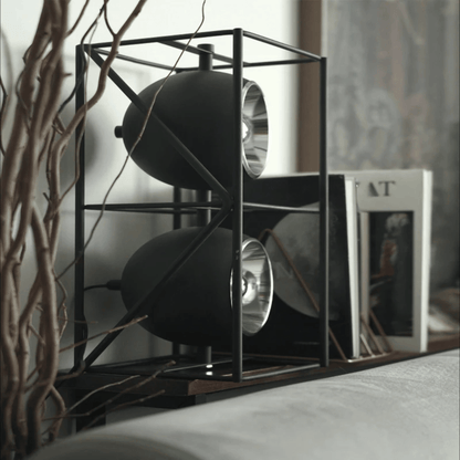 Modern black metal shelf with decorative items in a home setting