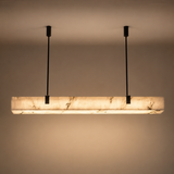 Modern pendant light with marble-like finish on a plain background